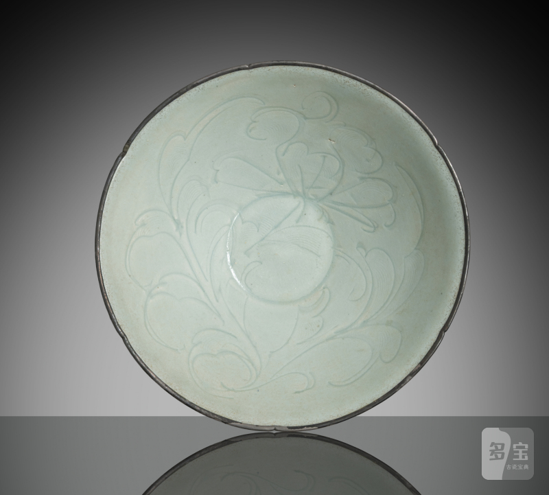 A slightly floriform 'qingbai' bowl with carved floral decoration and mounted silver rim